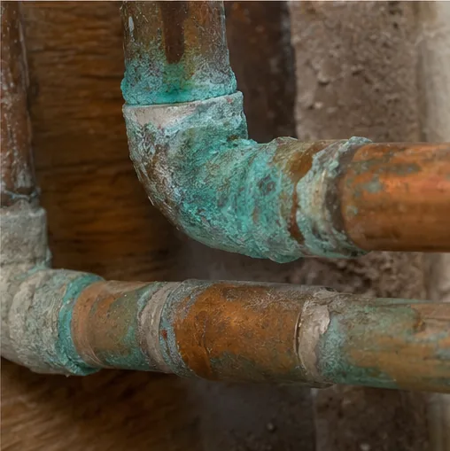 Burnsville MN home inspection showing a corroded cast-iron pipe joint typical of aging sewer laterals