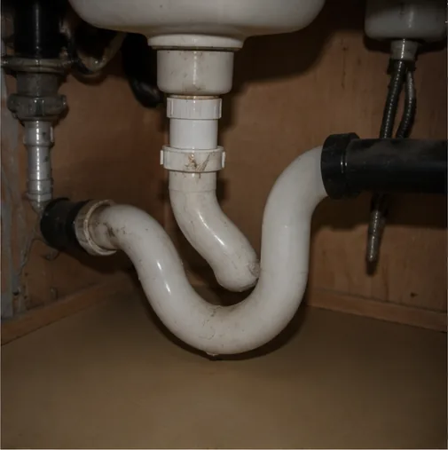 Burnsville MN home inspection showing under-sink P-trap plumbing connected to the drain system